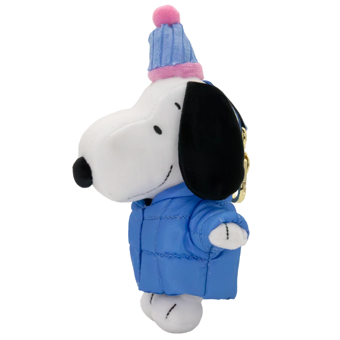 A plush keychain of Snoopy wearing a blue puffer jacket and a blue and pink striped knit beanie hat, shown against a plain white background.