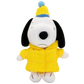 A plush toy of Snoopy wearing a yellow quilted jacket and a yellow and blue knit beanie hat, set against a plain white background.