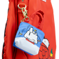A red nylon backpack with a small attached blue and white Snoopy fishing pouch charm, shown against a white background.