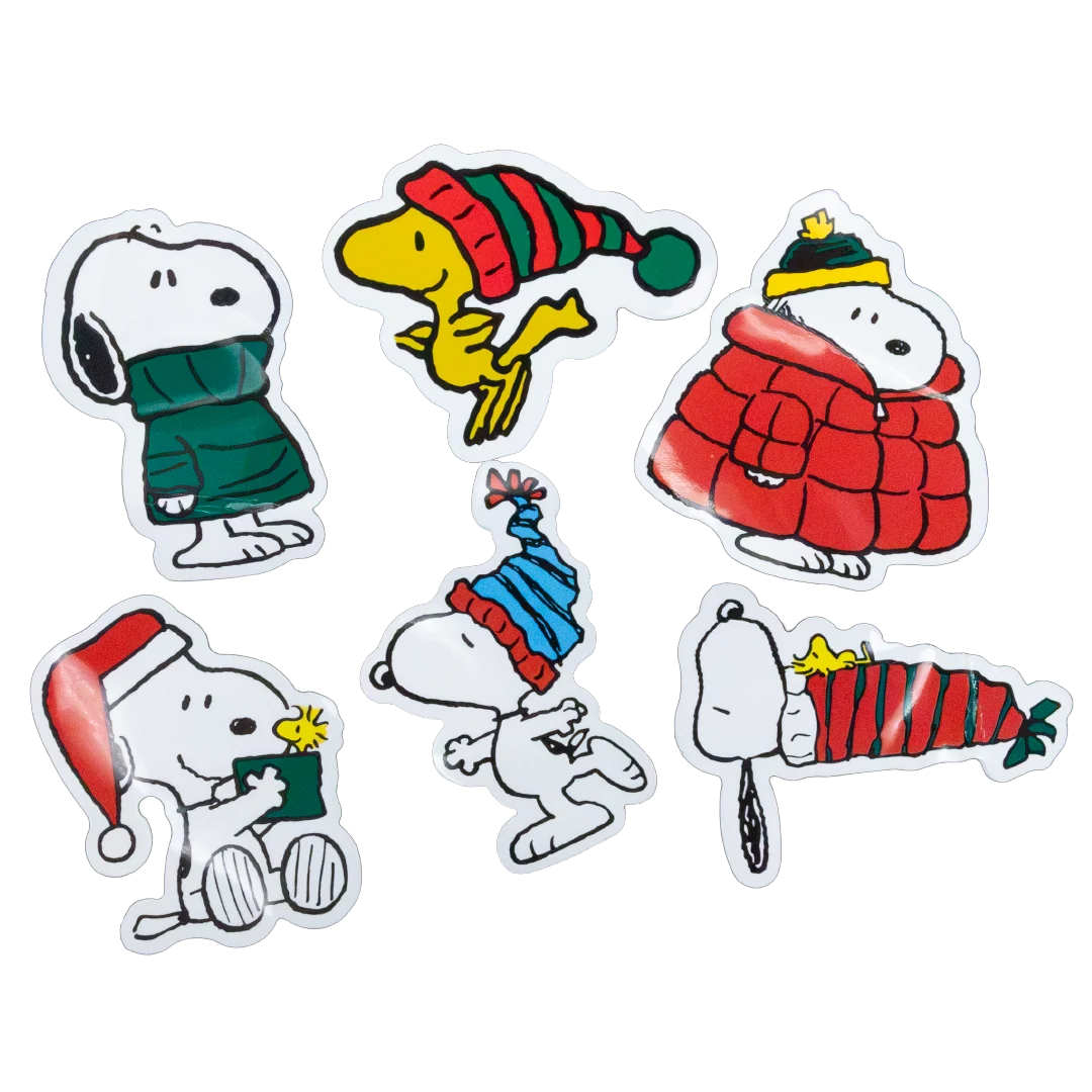 Six Snoopy and Woodstock holiday-themed die-cut stickers arranged on a plain white background, each showing different winter outfits and accessories.