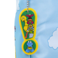 A Sesame Street keychain featuring characters Big Bird, Bertie, Ernie, Cookie Monster, and the Great Golden Feeder on a yellow and green exclamation mark design, attached to a silver ball chain and shown against a light blue patterned fabric background.