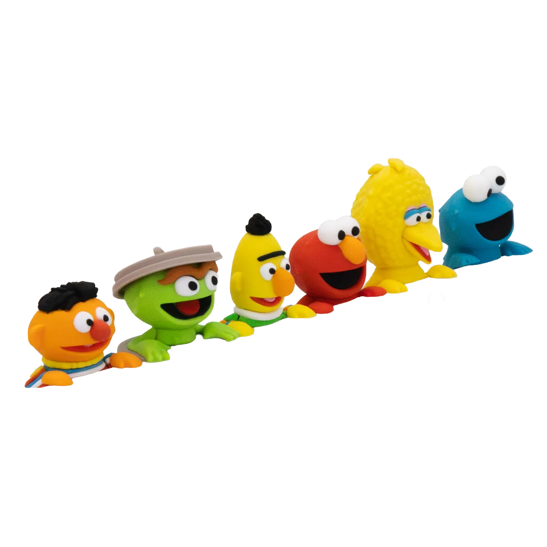 A set of six Sesame Street character toy figures lined up in a diagonal row against a plain white background. The characters include Ernie, Oscar, Bert, Elmo, Big Bird, and Cookie Monster.