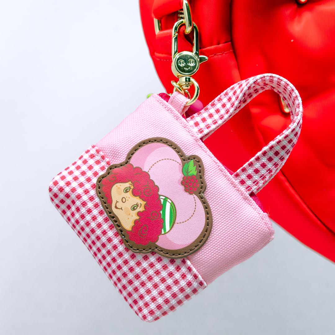 Mini tote bag featuring collectible Strawberry Shortcake Besties scented silicone charm