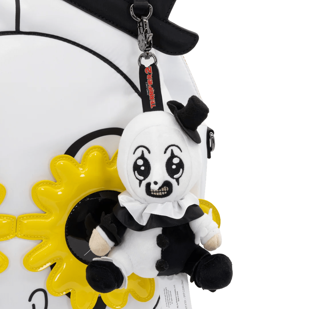 A plush keychain charm of a creepy clown character with a black top hat, white face, and black-and-white outfit, attached to a black strap with red text, shown against a white background.