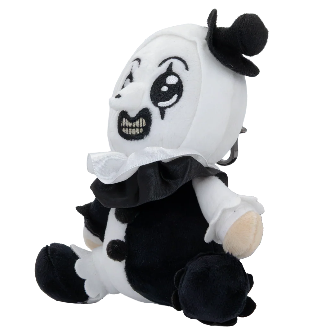 A plush toy shaped like a seated clown with a white head, black face details, black clothing, and beige skin-toned hands and feet, photographed on a plain white background.