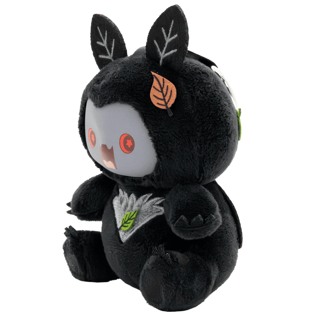 Black plush toy with leaf designs on a white background