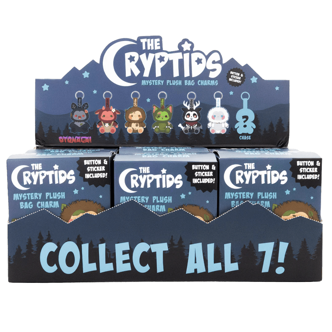Display of 'The Cryptids' mystery plush bag charm packaging with character illustrations on a white background.
