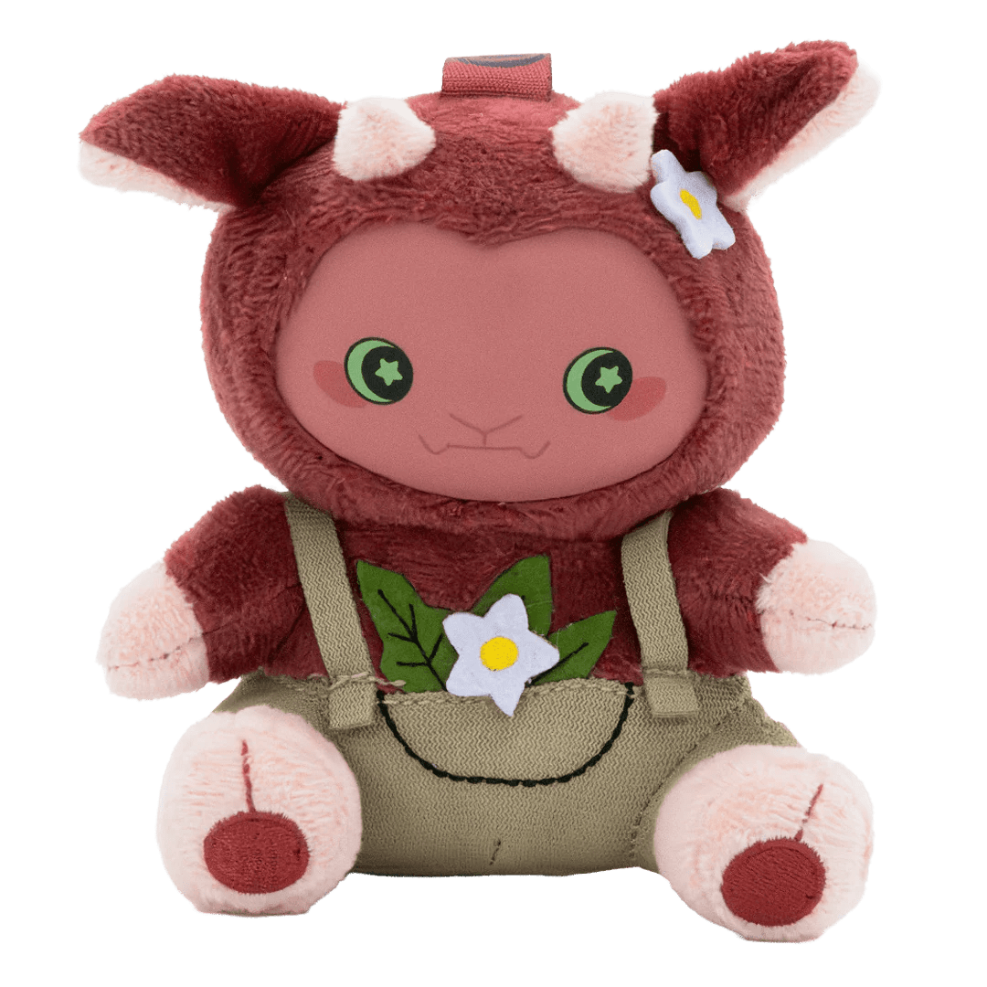 Plush toy with a red hood, green overalls, and flower decorations on a white background