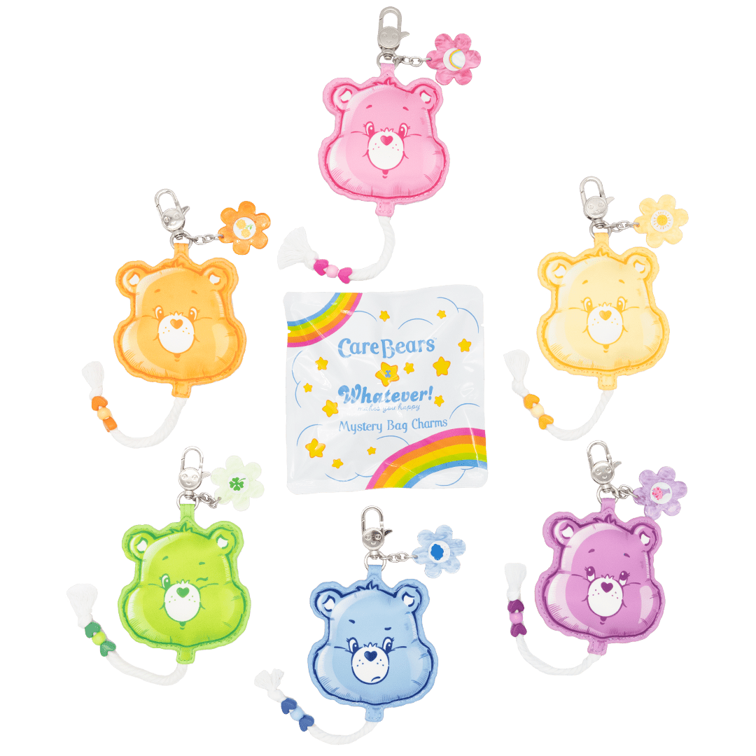 Set of colorful Care Bear keychains with a transparent packaging card featuring rainbow designs.