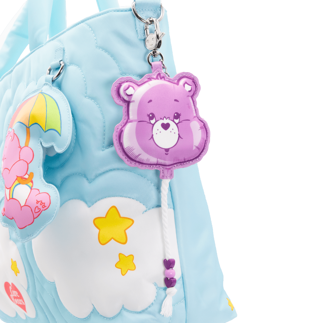 Light blue tote with cartoon bear keychain on a white background