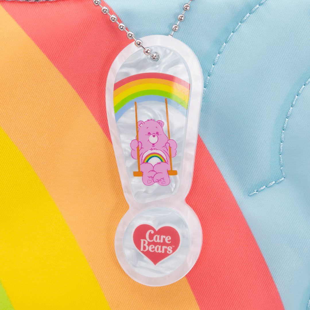 Care Bears-themed sandal charm with a bear on a swing against a colorful background