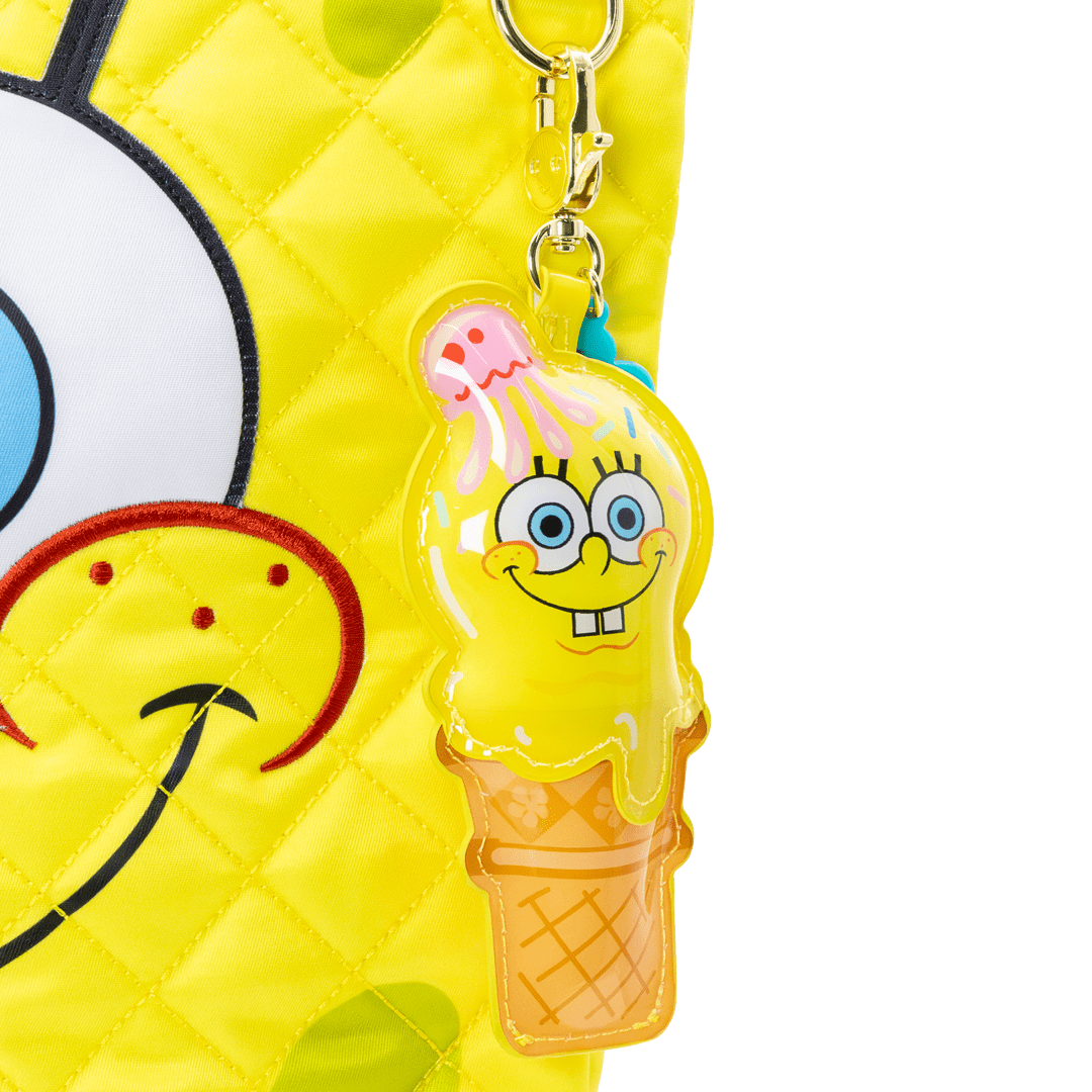 bag charms with a cartoon character in an ice cream cone shape attached to a yellow bag.
