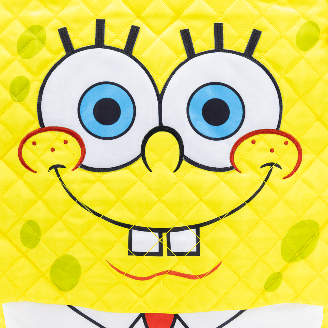 Close-up of a yellow cartoon character with a happy expression on a yellow background