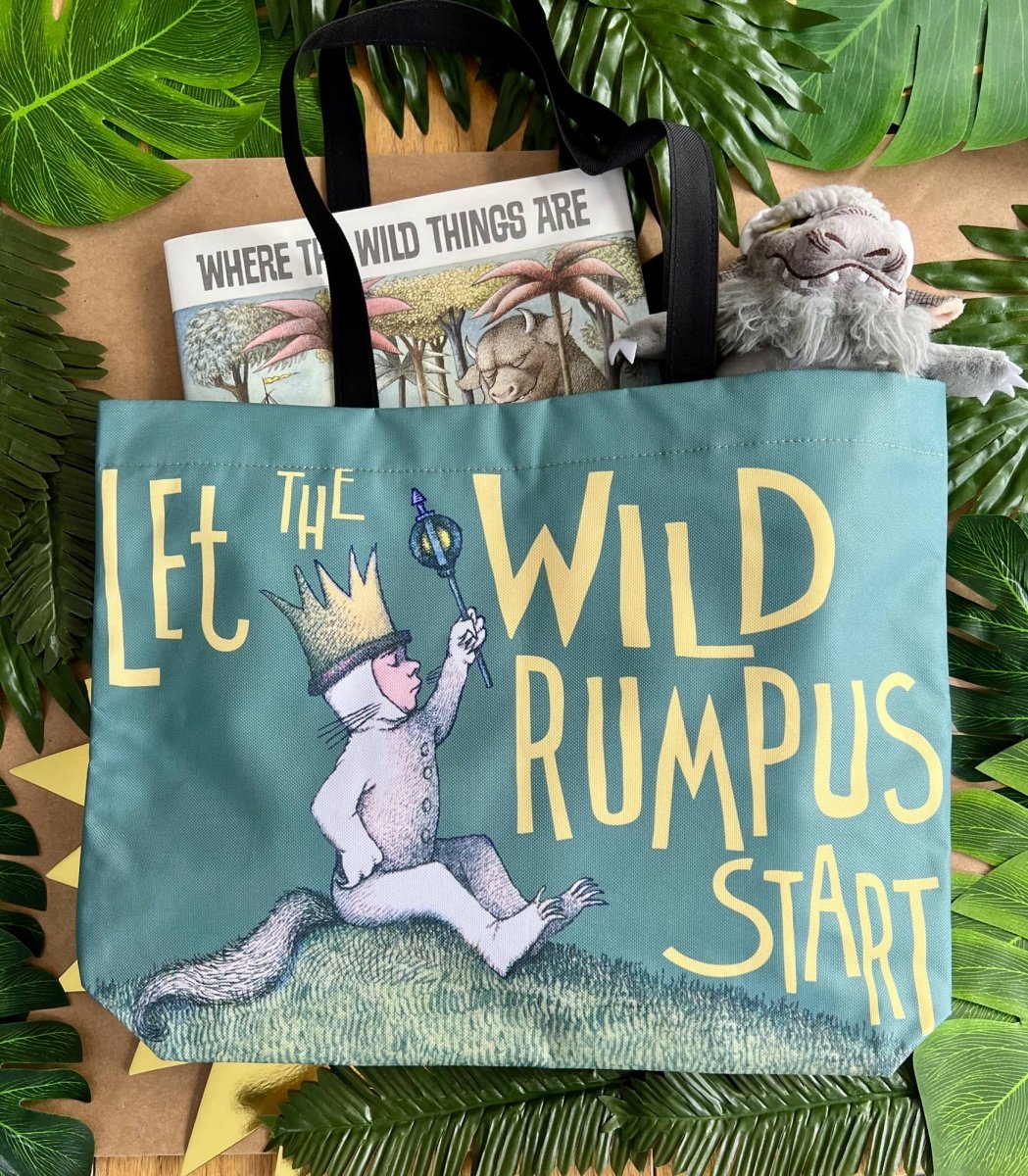 Tote bag with 'Let the Wild Rumpus Start' text and illustrations, surrounded by leaves.