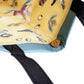 Close-up of a yellow cushion with cartoon characters and black straps on a white background