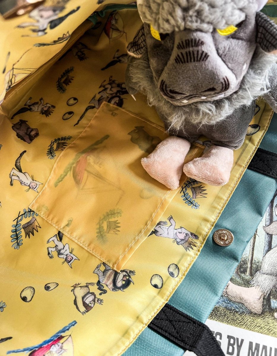 Plush donkey toy peeking out from a yellow fabric pocket with animal prints.