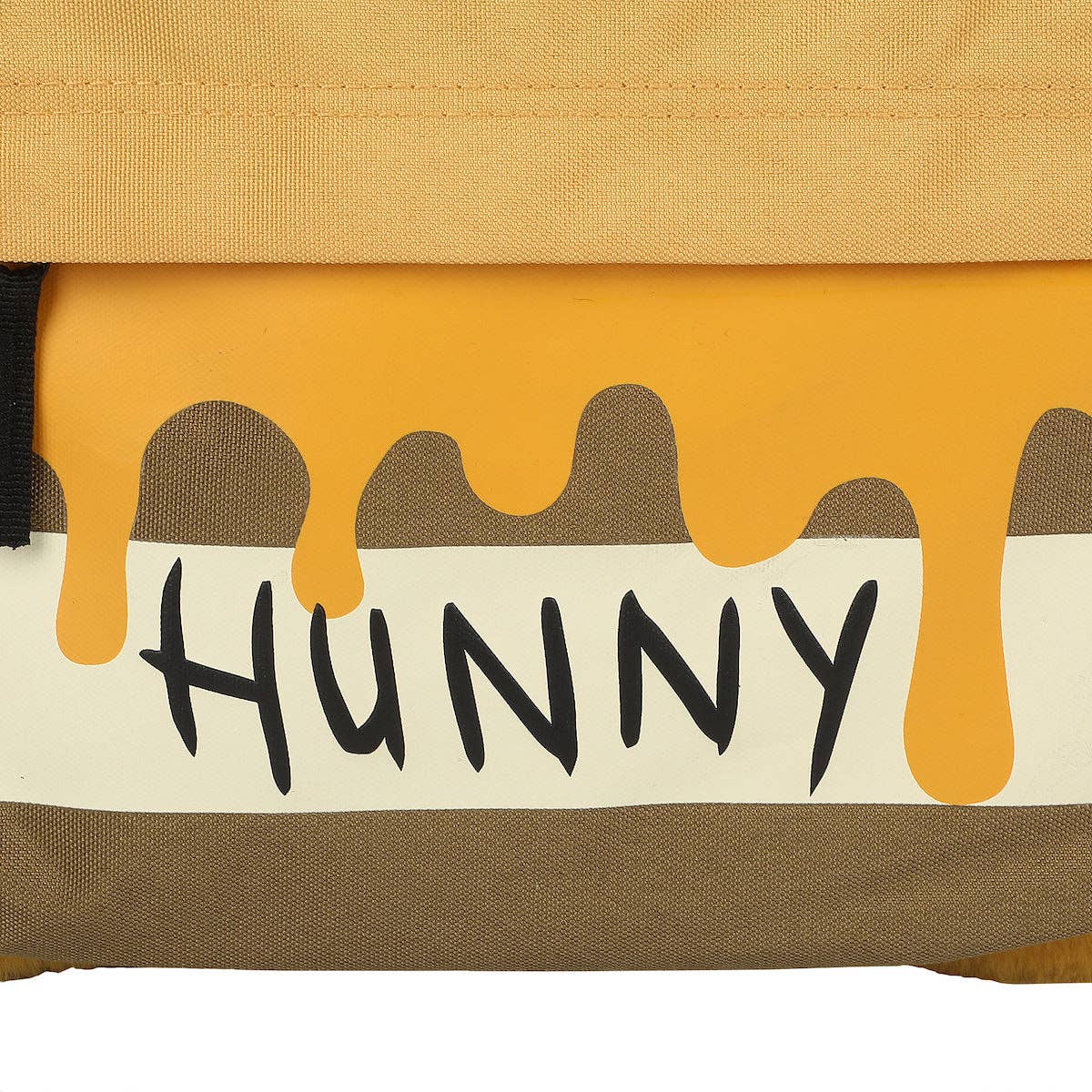 Close-up of a honeycomb with the word 'HUNNY' and honey dripping.
