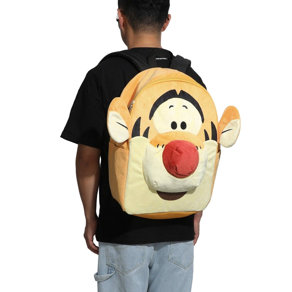 Person wearing a backpack with a cartoon character face on a white background