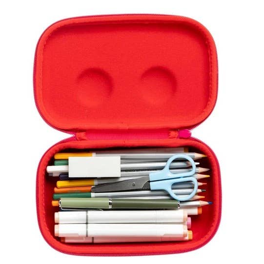 Red pencil case with stationery items on a white background