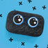 Black textured pouch with blue circular designs on a blue background with black cross symbols.