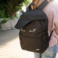 Person wearing a black backpack with a 'zipit' brand logo outdoors.