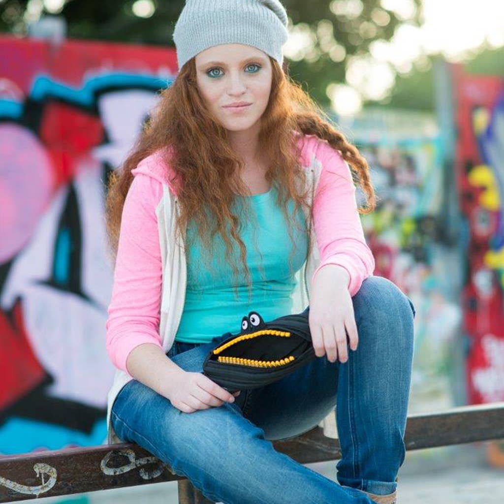 Woman sitting on a ledge with a colorful graffiti background