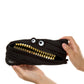 Black pouch with gold coins and googly eyes held by a hand on a white background