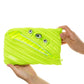 Bright green pouch with zipper and eye-like buttons held by a hand on a white background