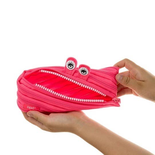 Pink zipper pouch with a face design held by a hand on a white background