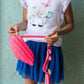Person holding a pink object against a light green background